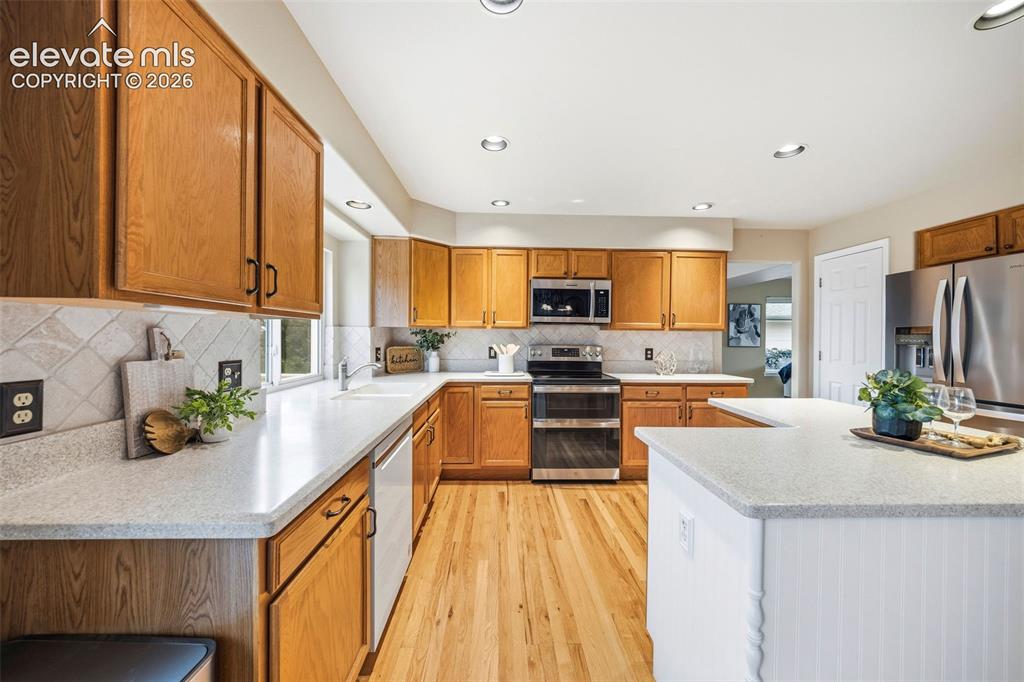 Image 9 of 50: Kitchen featuring a U-shaped countertop layout, stainless steel appliances,