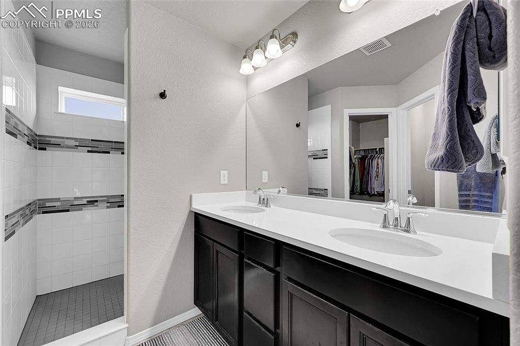 Image 18 of 42: En-suite bathroom features a large walk-in shower
