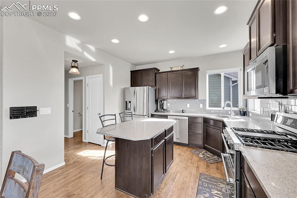 Image 8 of 42: Open Kitchen with entry from the garage and exit to back patio