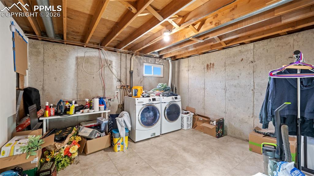 Image 14 of 23: Below grade area with washer and dryer