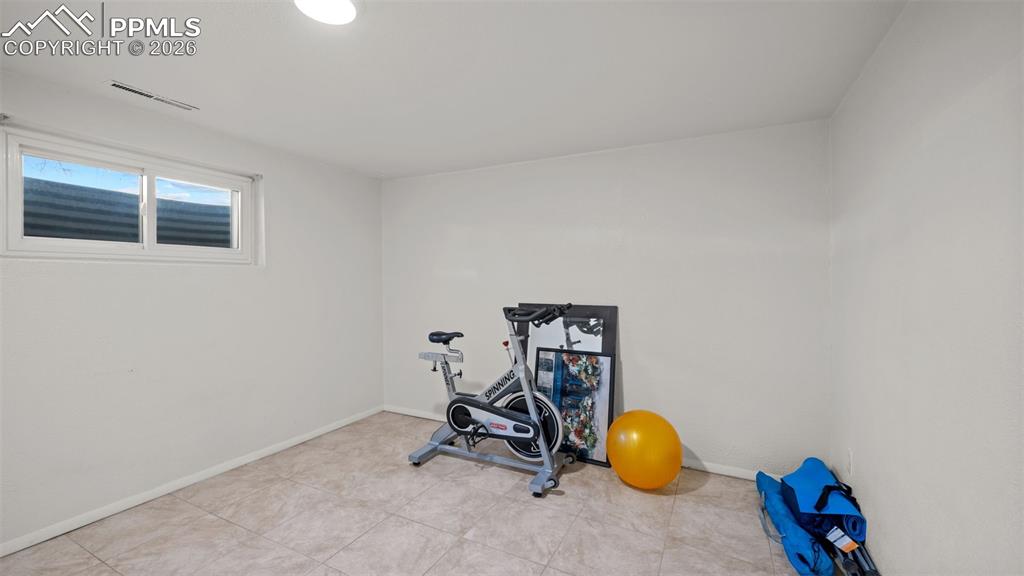Image 15 of 23: Exercise room featuring baseboards