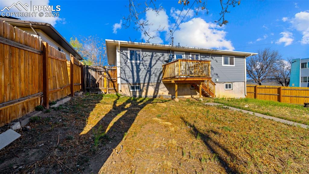 Image 21 of 22: Rear view of property with a fenced backyard and a deck