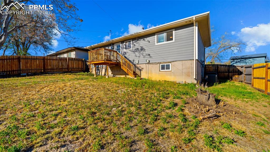 Image 22 of 22: Rear view of property with a fenced backyard and a deck