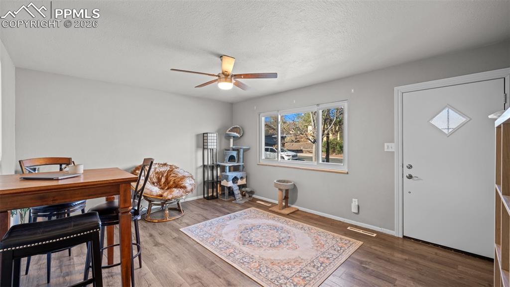 Image 4 of 22: Foyer entrance featuring wood finished floors, a ceiling fan, and a texture