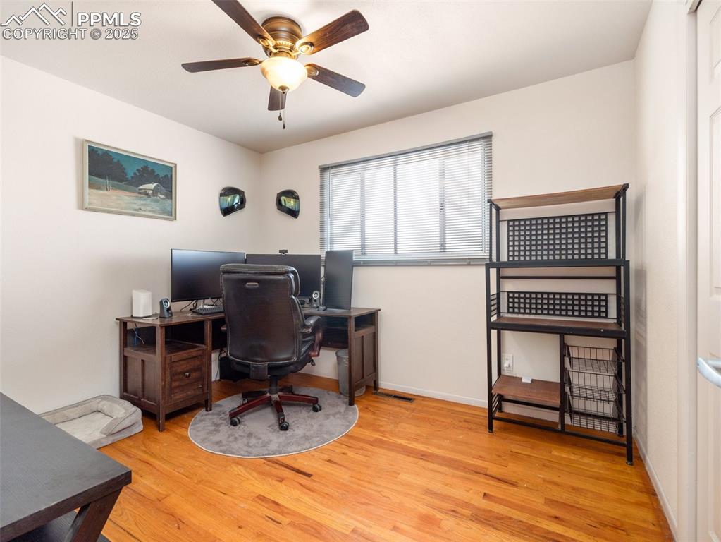 Image 11 of 16: Office with wood finished floors, a ceiling fan, and baseboards