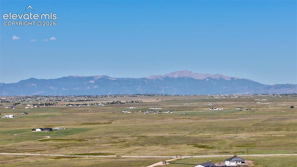 Image 1 of 9: Expansive landscape featuring distant mountains and open terrain