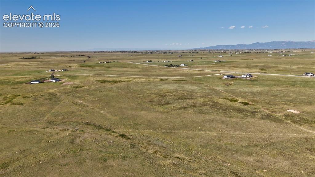 Image 7 of 9: Expansive rural landscape featuring scattered residential properties, a cle