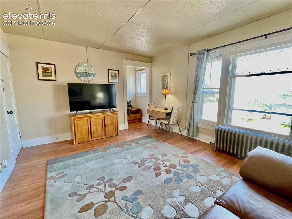 Image 21 of 50: Wood-finish flooring throughout