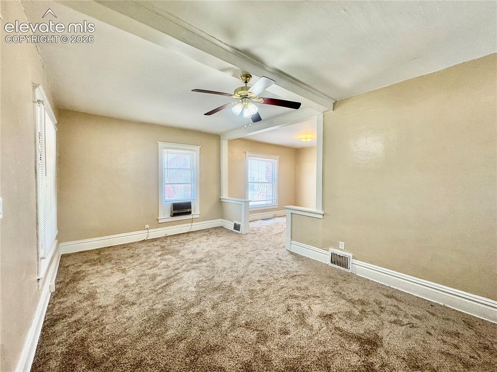 Image 24 of 48: Spacious room featuring neutral wall finishes, plush carpet flooring, ceili