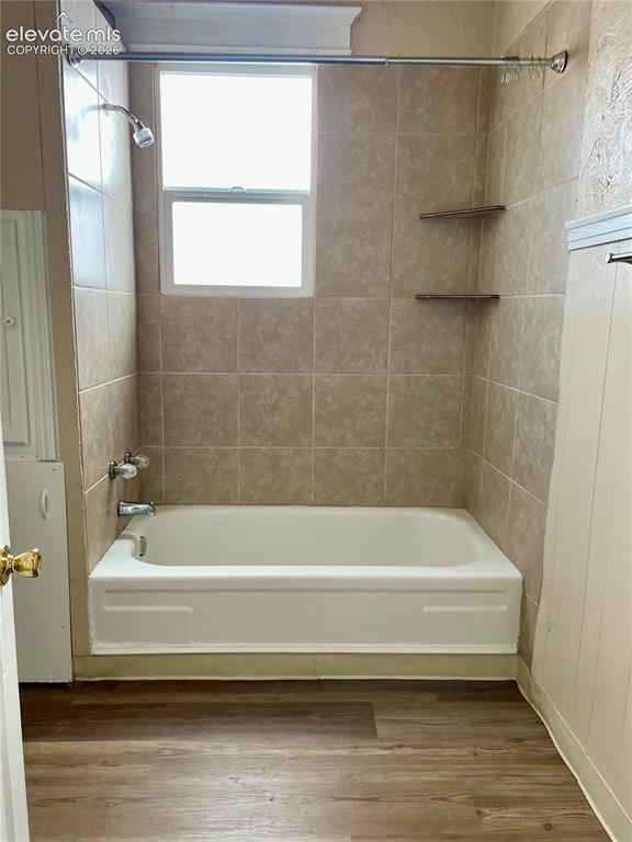 Image 27 of 50: Kitchen featuring tile flooring, white cabinetry, integrated appliances, an
