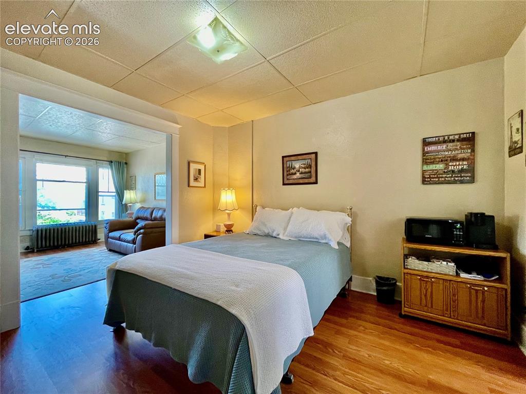 Image 43 of 48: Wood-finish flooring throughout, recessed ceiling light, and an open doorwa