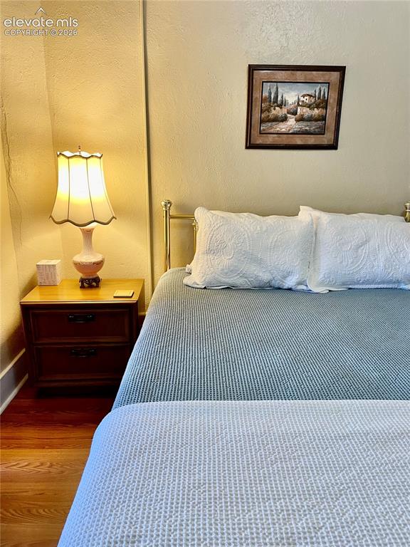 Image 44 of 48: Inviting bedroom featuring warm ambient lighting from a traditional table l