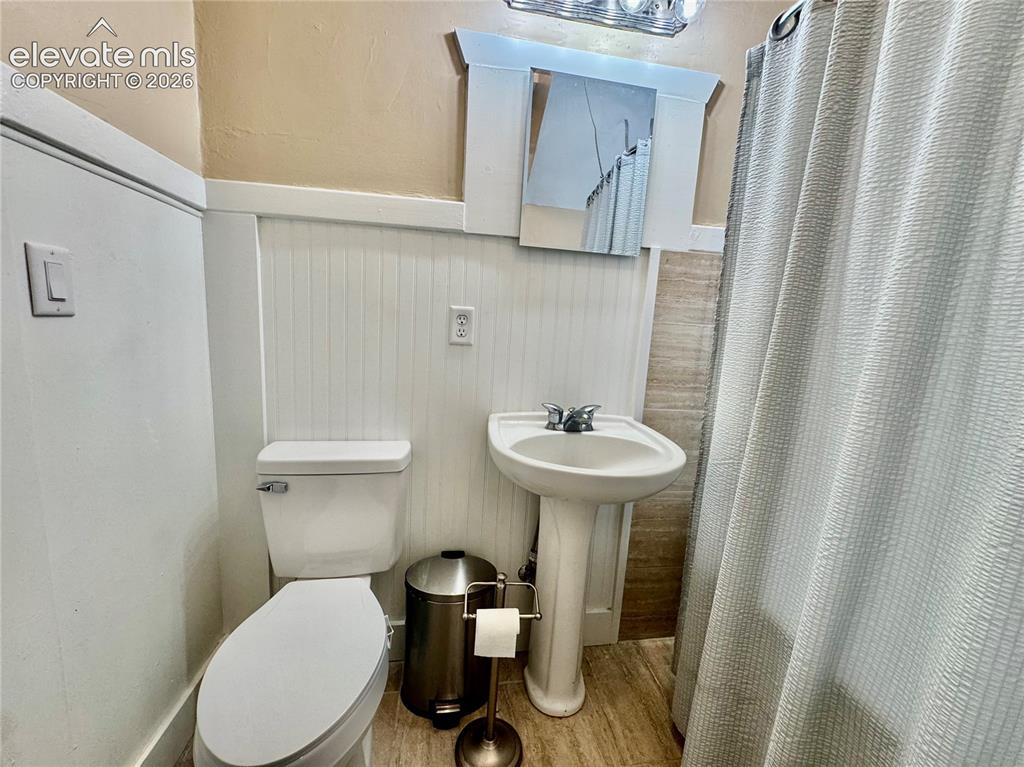 Image 8 of 50: Kitchen featuring tile flooring, white cabinetry, integrated appliances, an