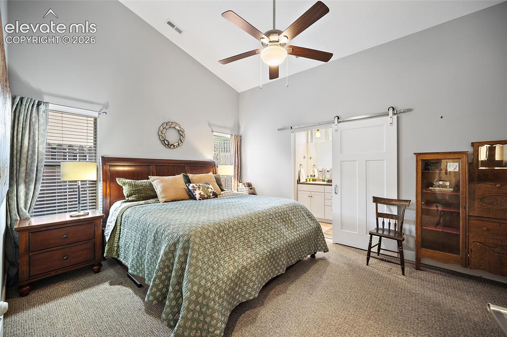 Image 16 of 25: Primary Bedroom on Main Level - Vaulted Ceiling, Door to Patio, Walk-in Clo