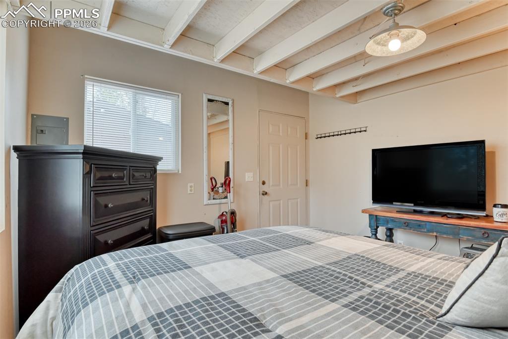 Image 17 of 48: Bedroom featuring electric panel and beam ceiling
