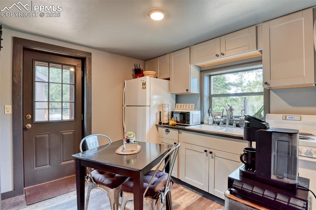 Image 3 of 48: Kitchen featuring freestanding refrigerator, light wood finished floors, st