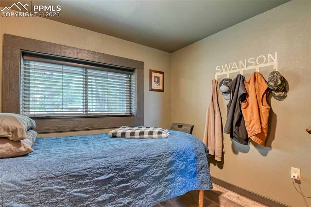 Image 9 of 48: Bedroom featuring wood finished floors and baseboards