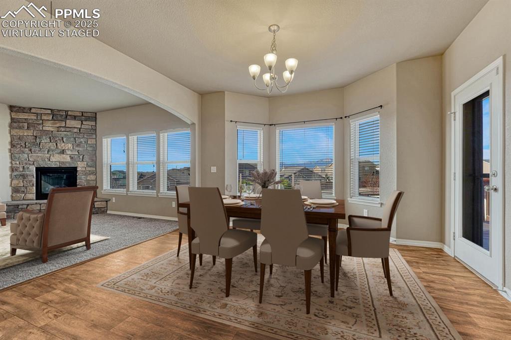 Image 6 of 50: Pikes Peak view! Dining room virtually staged