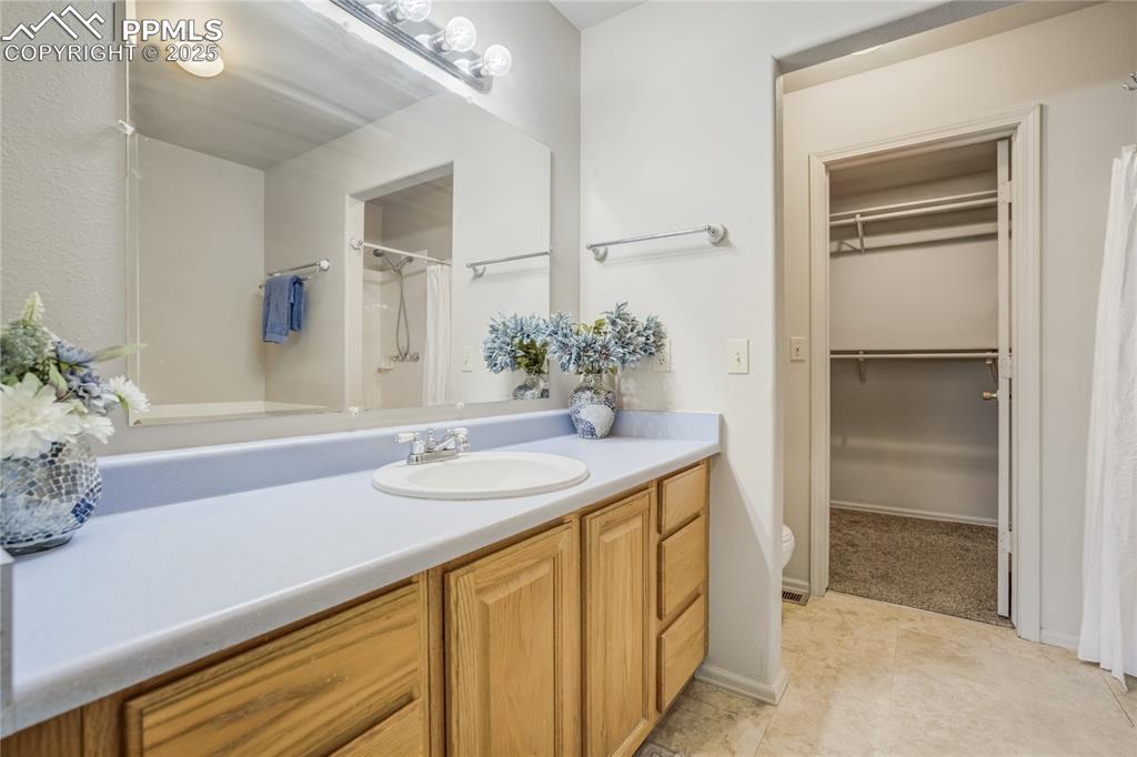 Image 18 of 42: Primary bedroom attached bath features tub, step in shower, toilet, extende