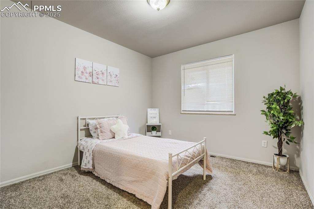 Image 21 of 42: Front Bedroom 2 features carpet and walk in closet