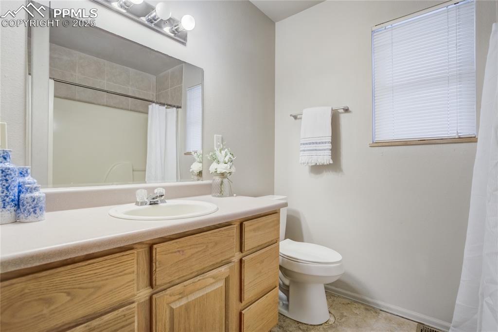 Image 25 of 42: Hall bath features linoleum flooring, linen closet single sink vanity, toil
