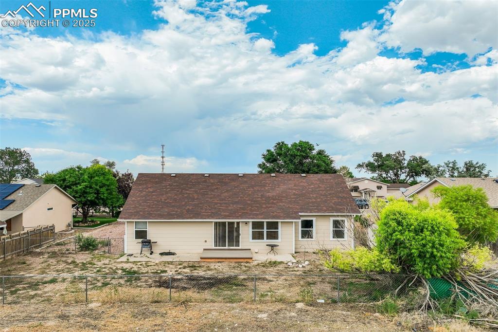 Image 32 of 42: Back of house with a fenced backyard and a patio