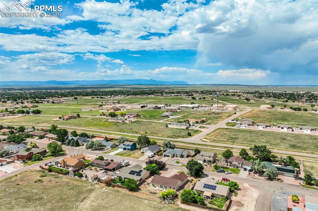 Image 36 of 42: Aerial perspective of suburban area with a mountain backdrop