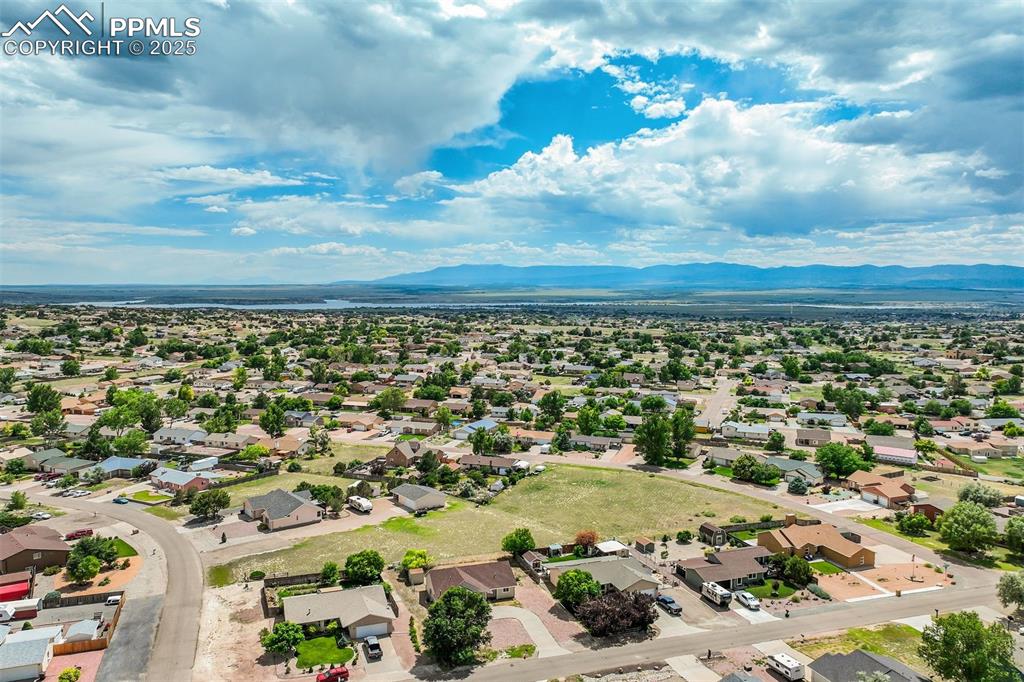Image 39 of 42: Aerial view of residential area with a water and mountain view
