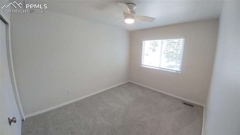 Image 19 of 39: Carpeted empty room featuring baseboards and ceiling fan