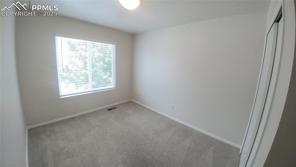 Image 21 of 39: Spare room with carpet flooring and baseboards