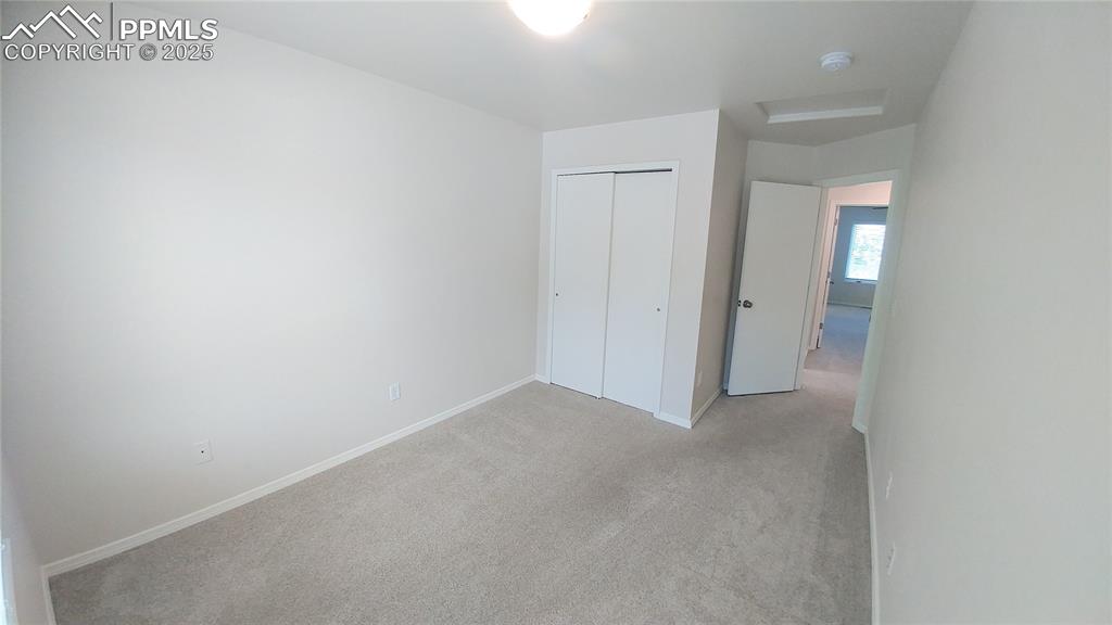 Image 22 of 39: Unfurnished bedroom featuring light colored carpet and a closet