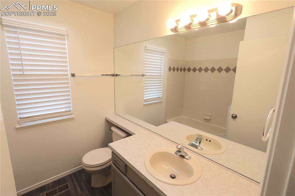 Image 23 of 39: Bathroom featuring vanity and wood finished floors