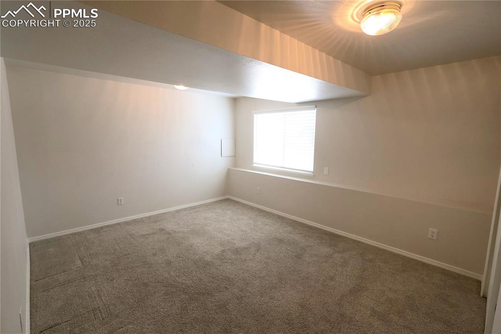 Image 30 of 39: Additional living space featuring carpet floors and baseboards