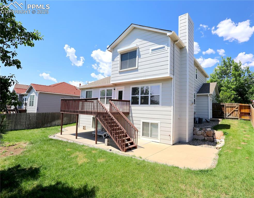Image 32 of 39: Rear view of house with a patio, a deck, stairs, and a fenced backyard