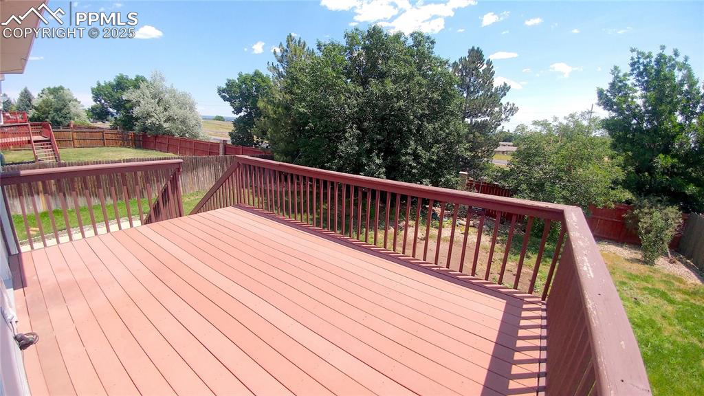 Image 34 of 39: Deck with a fenced backyard