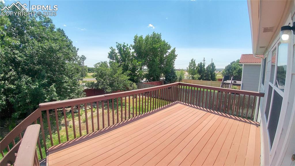 Image 35 of 39: Wooden terrace featuring a fenced backyard