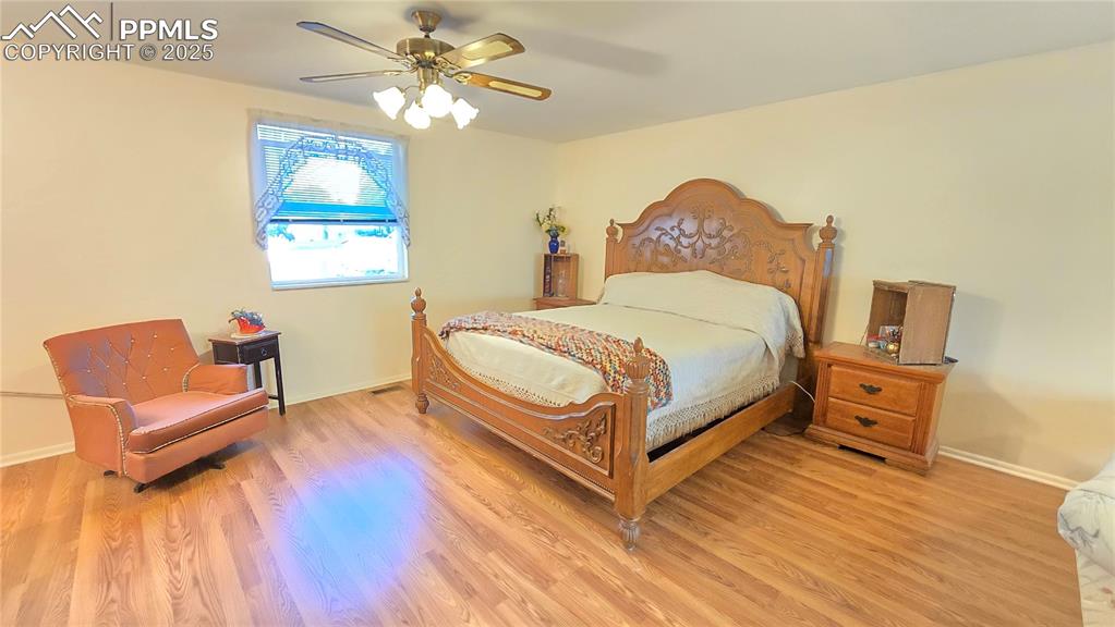Image 10 of 42: Bedroom featuring a ceiling fan and light wood finished floors