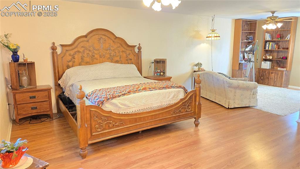 Image 11 of 42: Bedroom with light wood-style flooring and ceiling fan