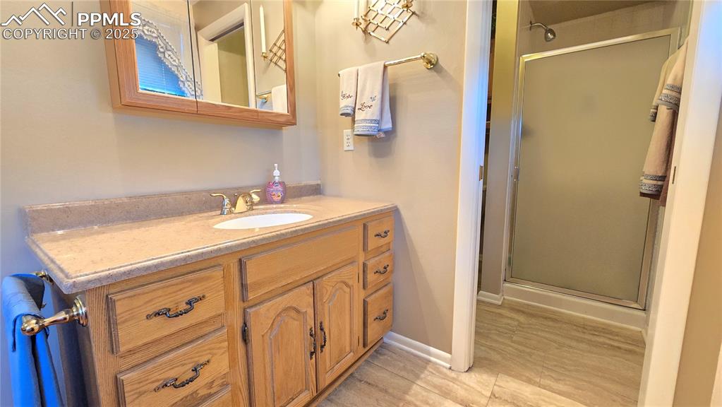 Image 13 of 42: Bathroom featuring a stall shower and vanity