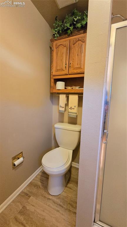 Image 14 of 42: Full bathroom with light wood-style floors and a shower stall