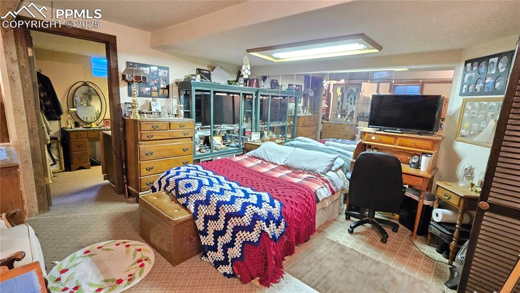 Image 23 of 42: Bedroom with carpet and an office area
