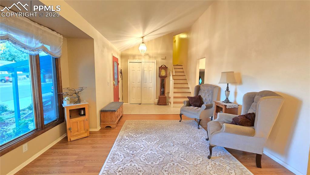 Image 3 of 42: Living area featuring stairs and light wood-style flooring