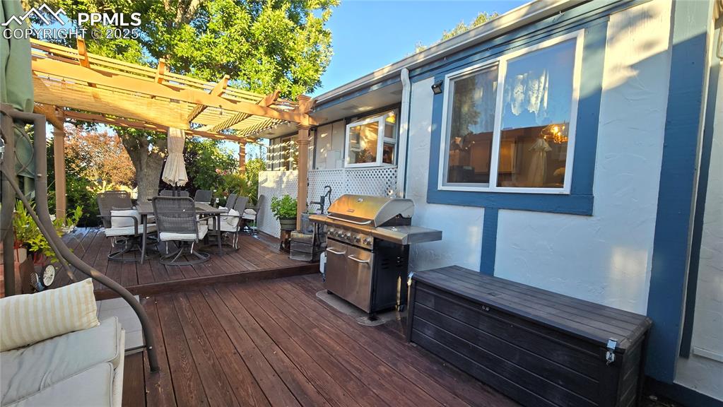 Image 33 of 42: Deck featuring outdoor dining area, a grill, and a pergola