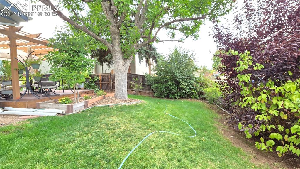 Image 38 of 42: View of yard with a wooden deck and a pergola