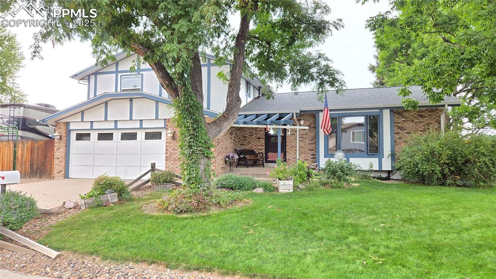Image 42 of 42: View of front of home featuring brick siding, driveway, an attached garage,