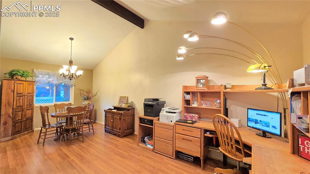 Image 6 of 42: Home office featuring light wood-style floors and a chandelier