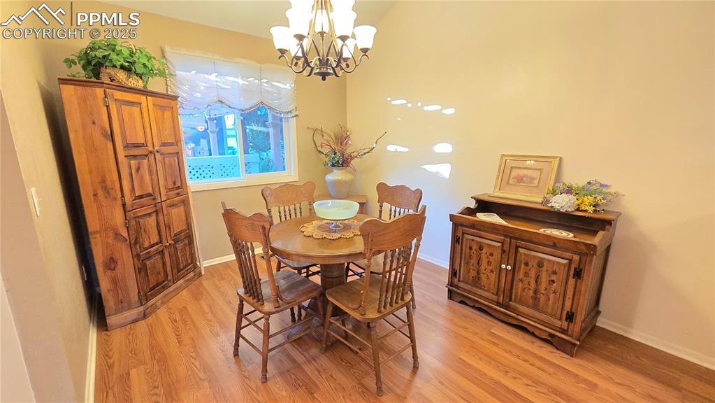 Image 7 of 42: Dining space featuring light wood-type flooring and a chandelier