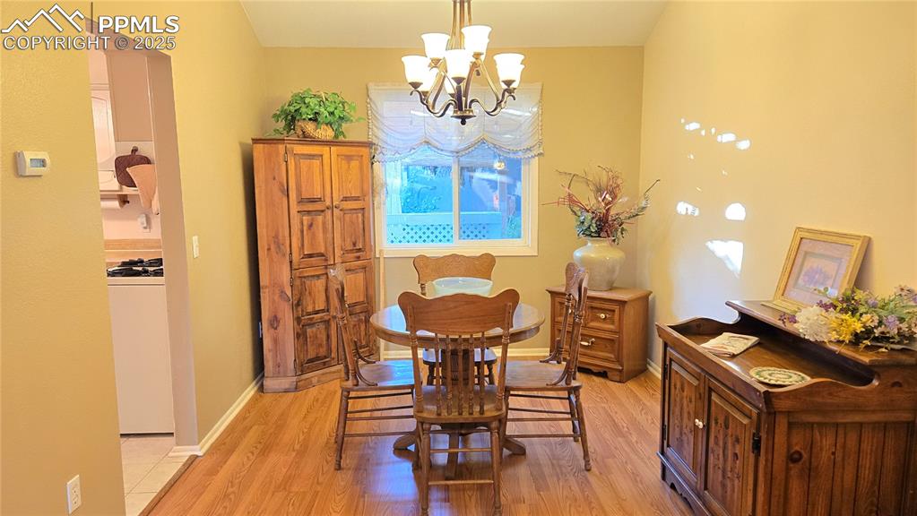 Image 8 of 42: Dining space featuring light wood-style floors and a chandelier