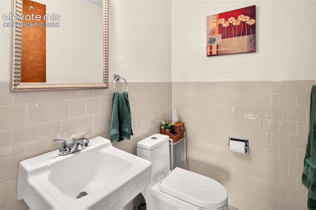 Image 12 of 49: A half bath is tucked in between the dining room and kitchen