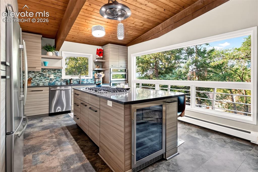 Image 13 of 49: The kitchen is amazing! Custom cabinetry, Quartz countertops, and glass til